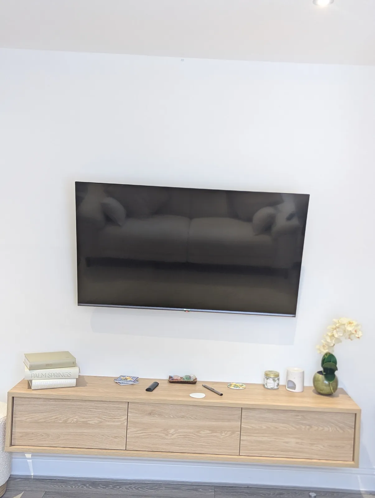 Wall-mounted TV above a floating media console