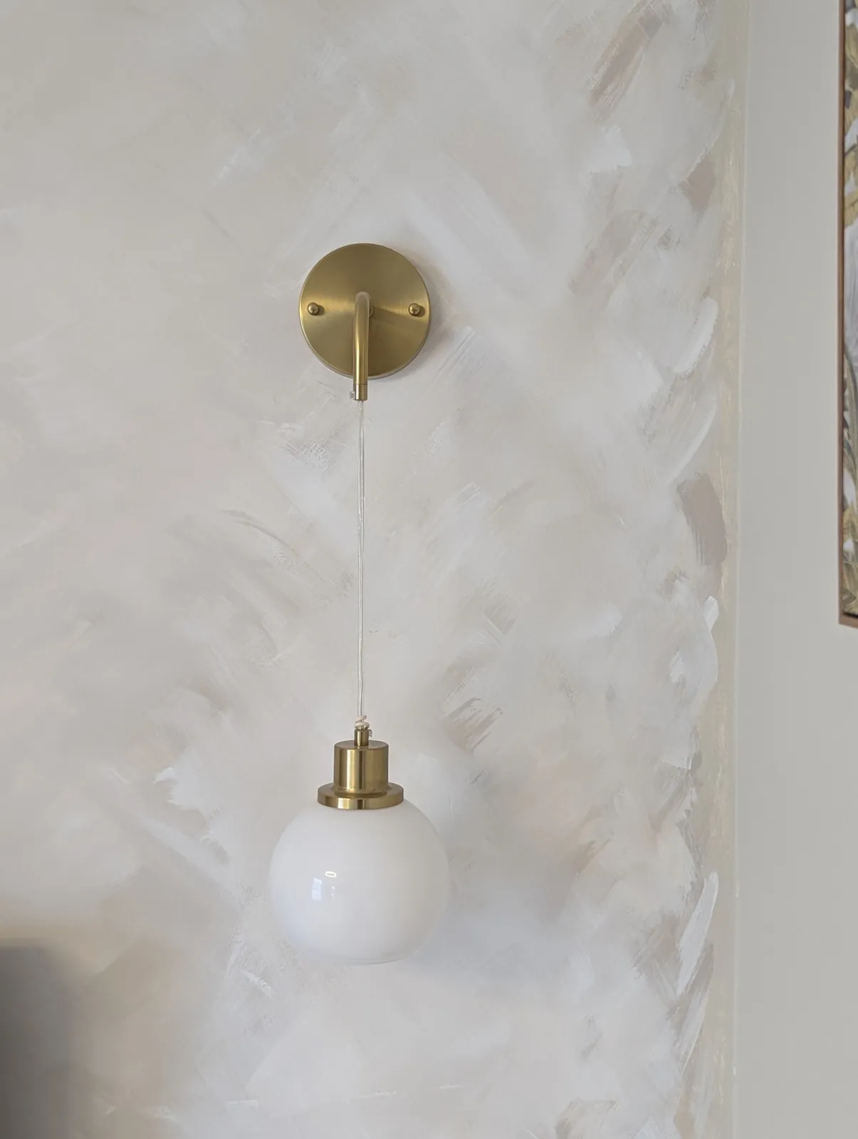Brass globe wall light fitted